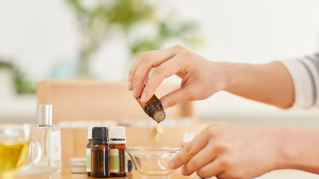 Woman mixing essential oils in bowl