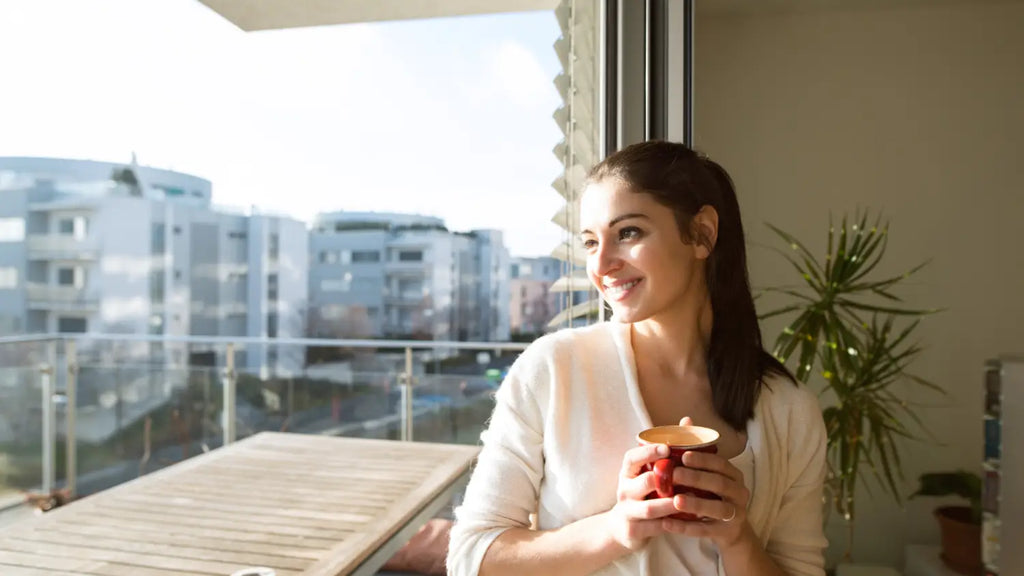 Woman drinking coffee in the balcony