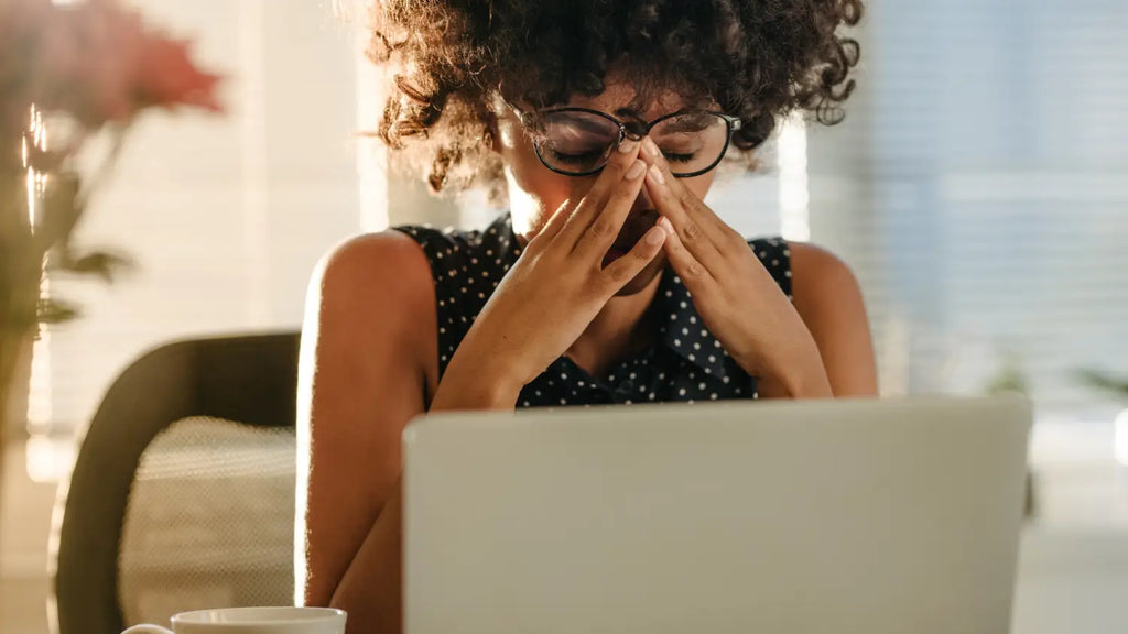 Woman feeling stressed while working