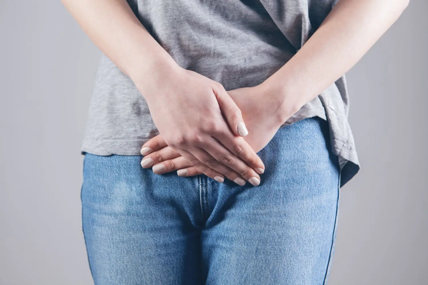 Woman holds on to the bottom of the abdomen