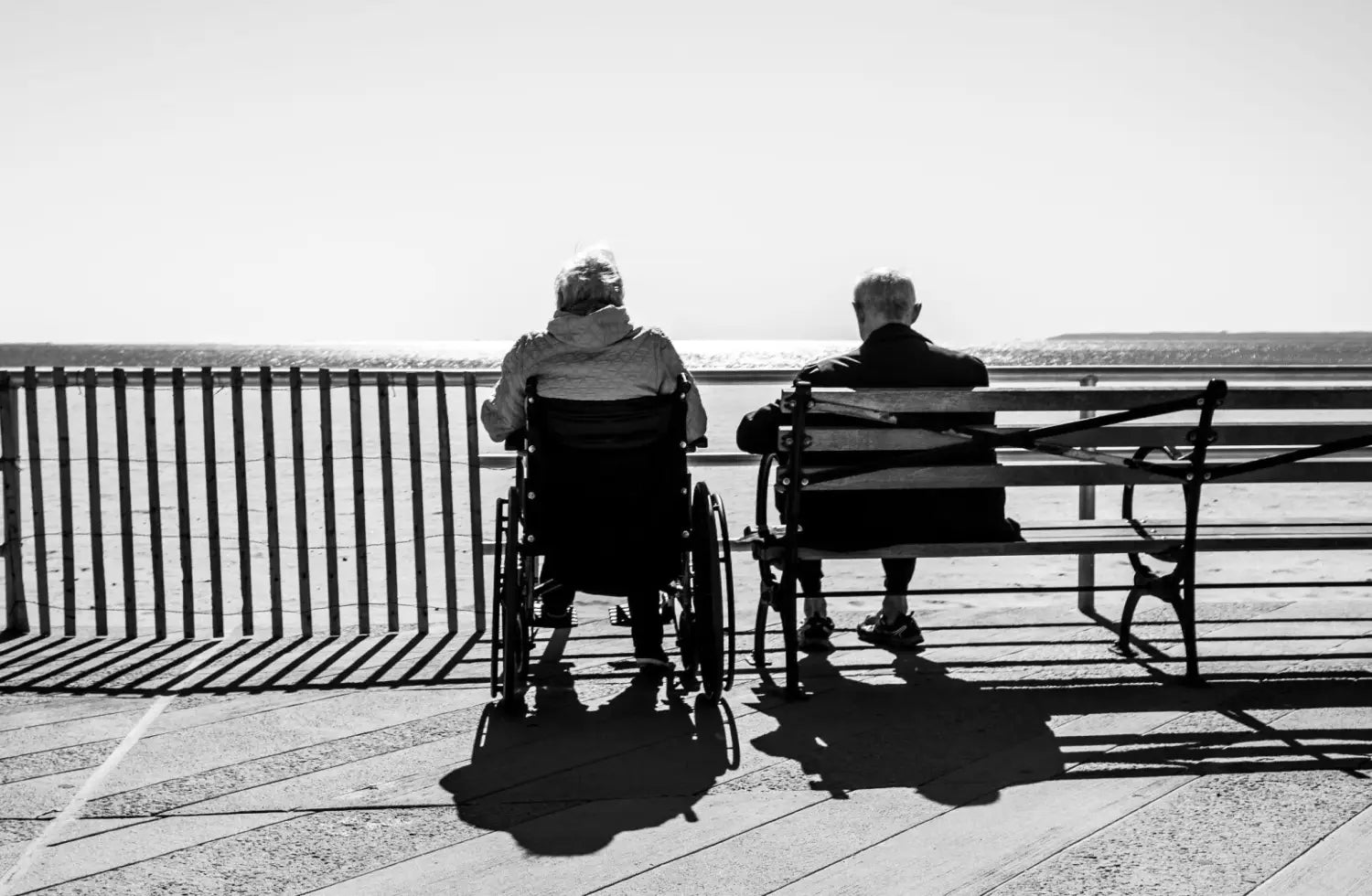 Elderly couple sitting and looking at the landscape.