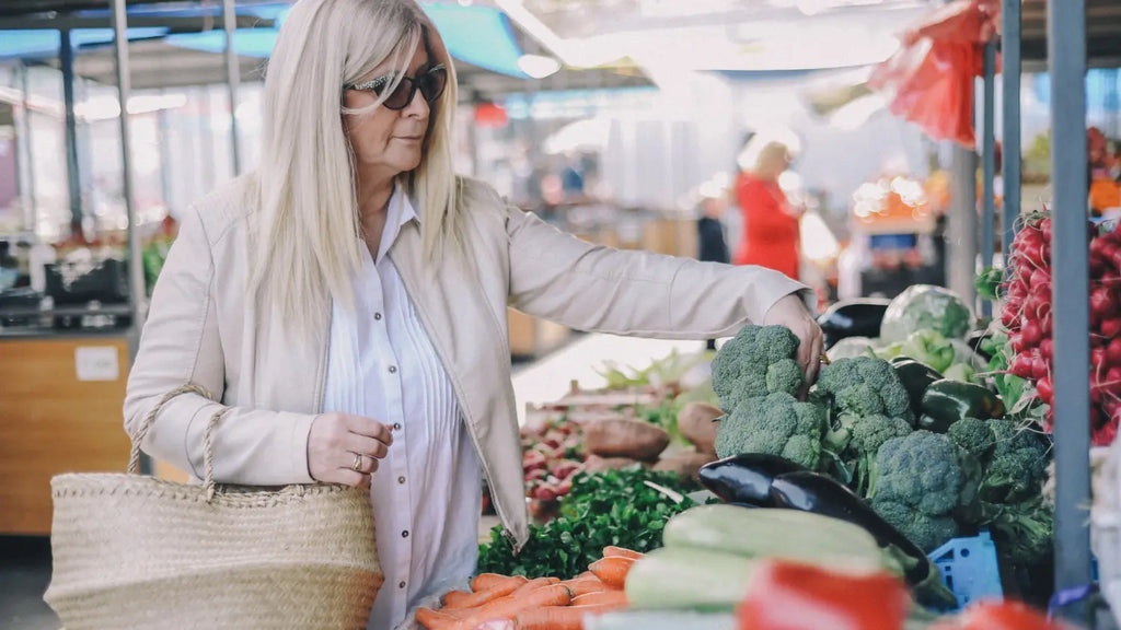 Woman picking vegetables in open market