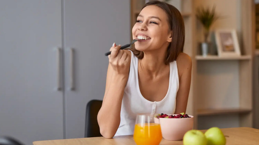 Woman eating and smiling