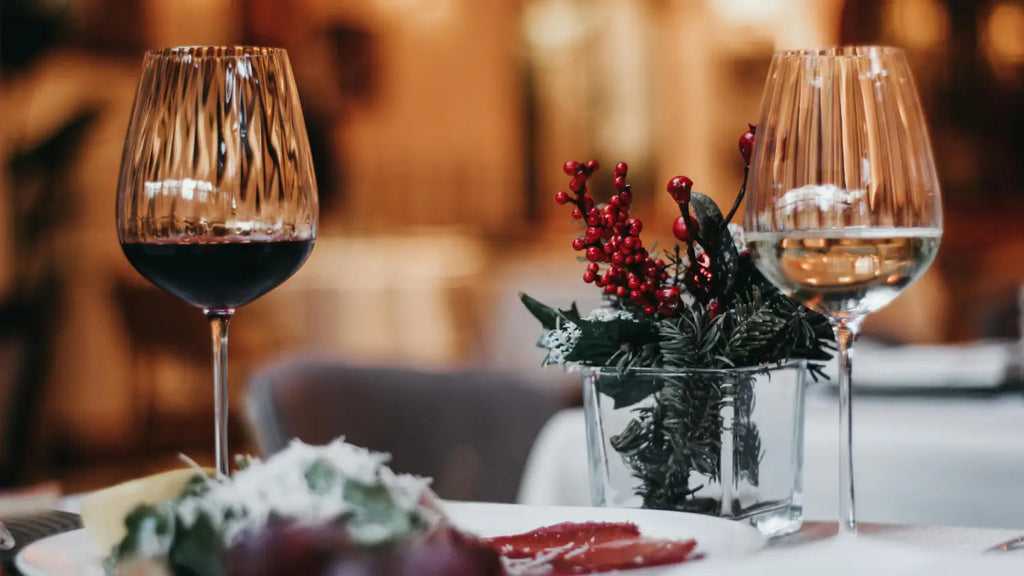 Glass of wine and glass of water on top of holiday dinner table