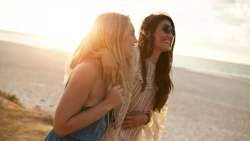 Two friends laughing and hugging