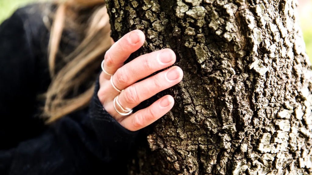 Woman touching tree