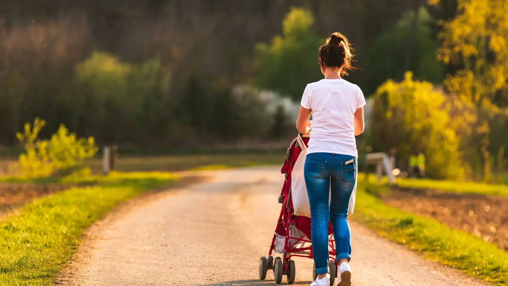 Woman taking a walk with baby in stroller