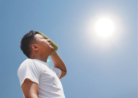 Man with towel suffering from heat stroke outdoors