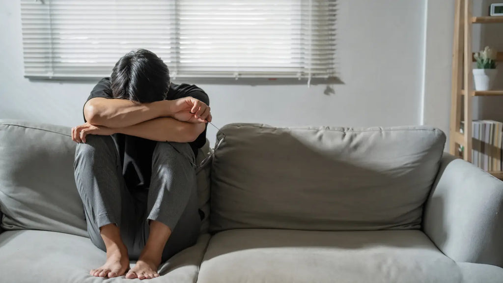 Man sitting on the couch feeling down