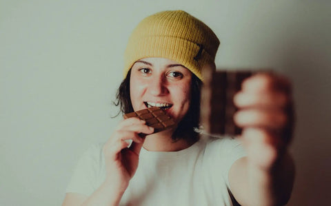 Woman eating a chocolate tablet