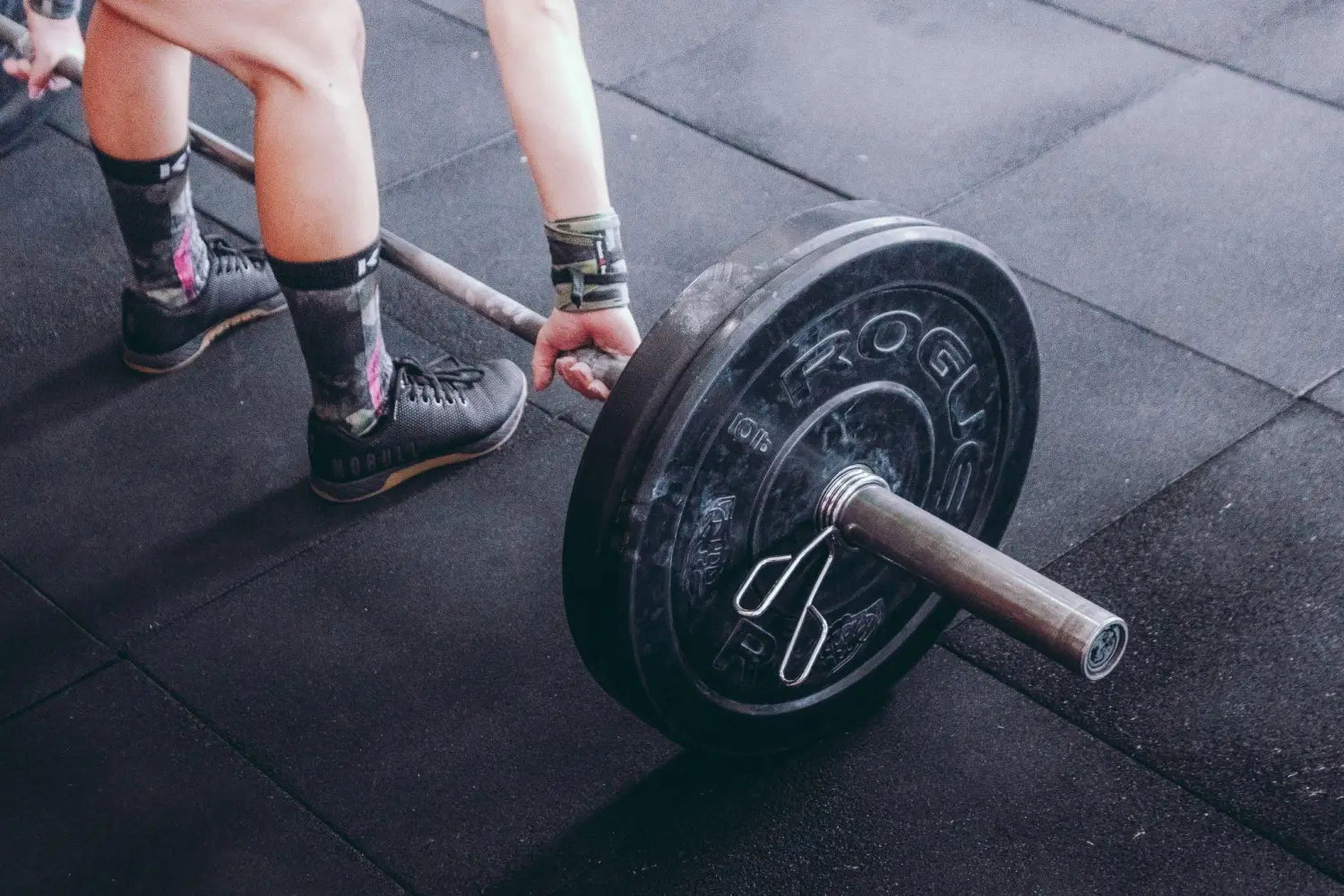 Person lifting weights at a gym.