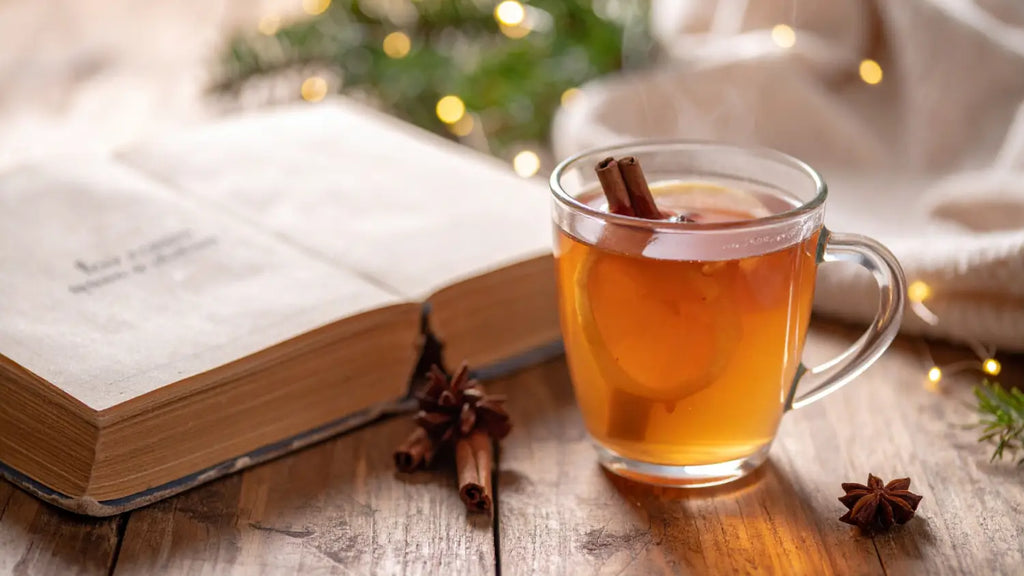 Book and cup of tea over table