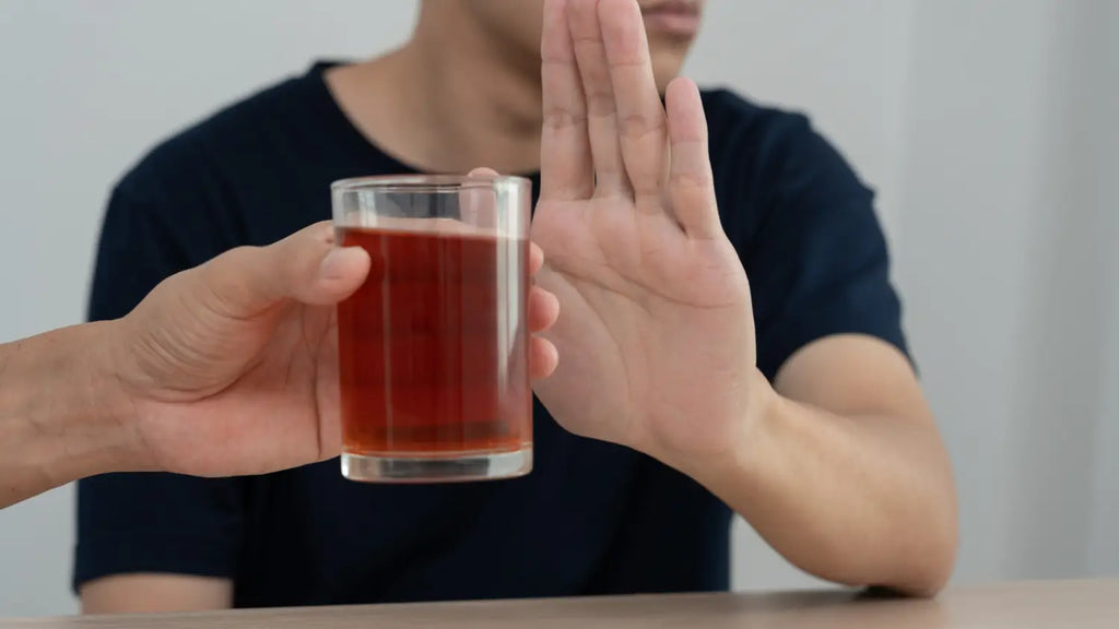 Man refusing glass of beer