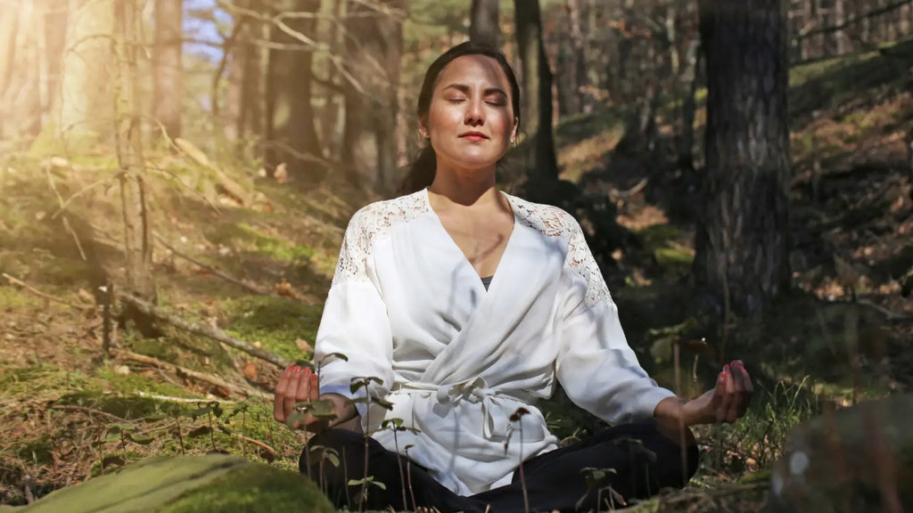 Woman meditating in forest