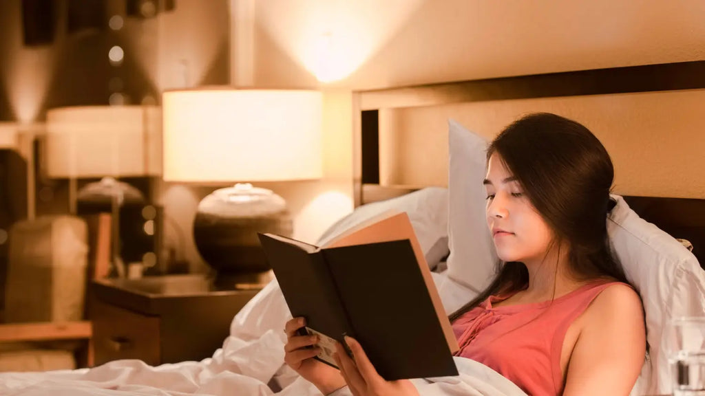 Woman reading a book in bed