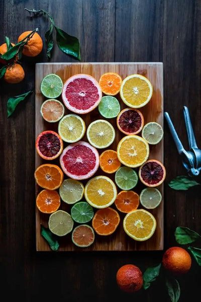 sliced citrus fruits on a wooden board