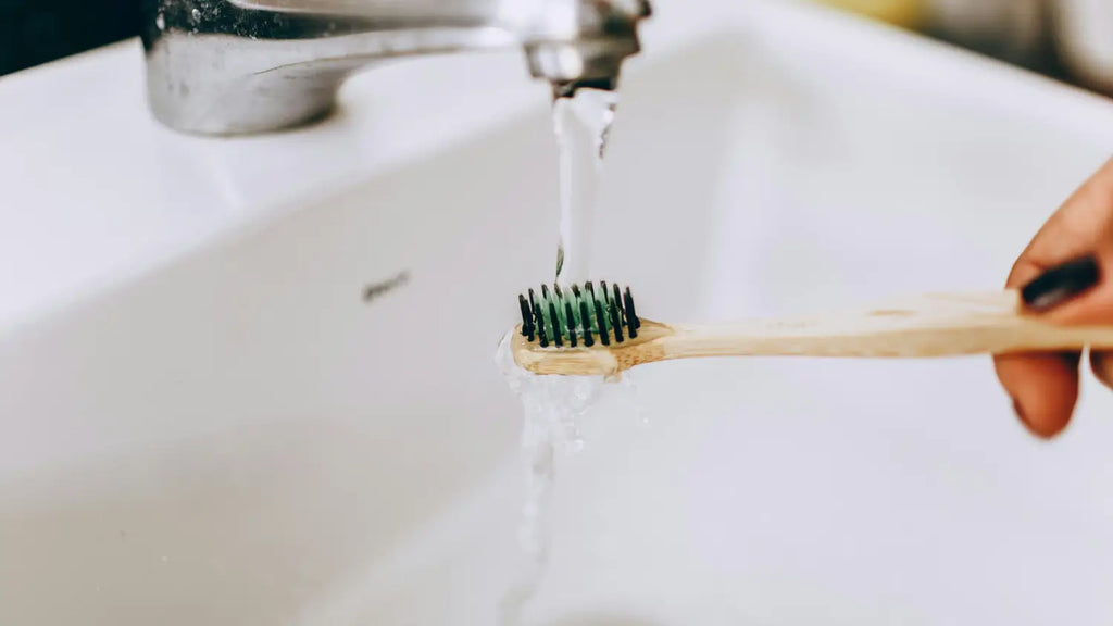 Toothbrush under tap water