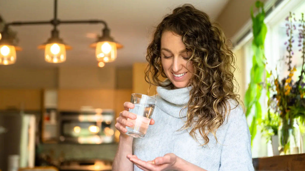 Woman taking natural supplement