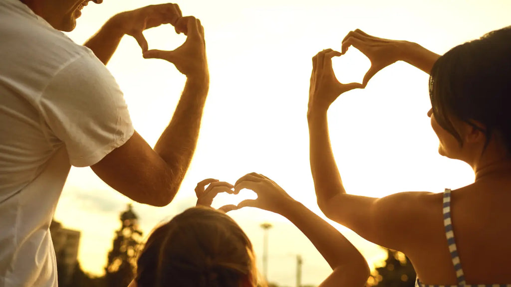 Family making heart-shaped hands
