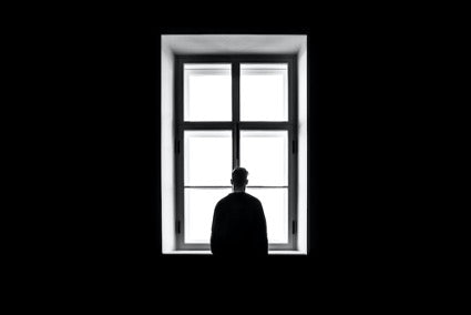 Man looking through a window