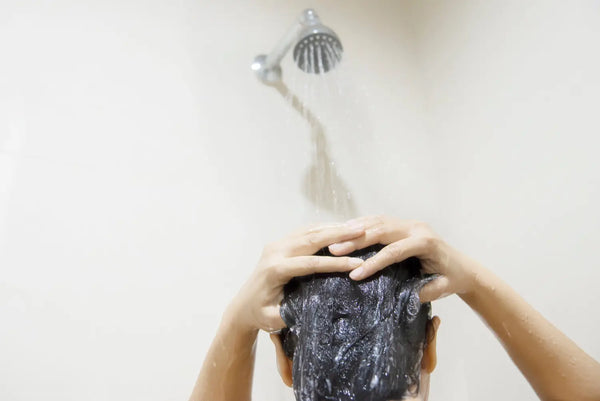 Woman washing her hair in the shower.