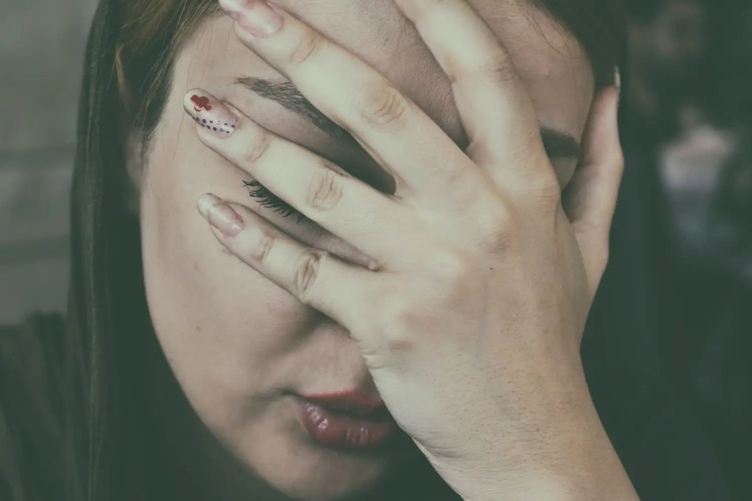 Woman holding her head in her hands