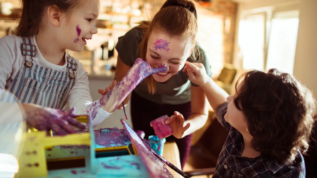 Mom and kids painting, making a mess and having fun