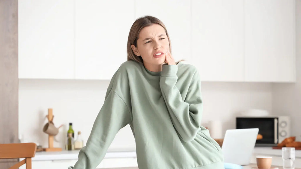 Woman struggling with tooth sensitivity