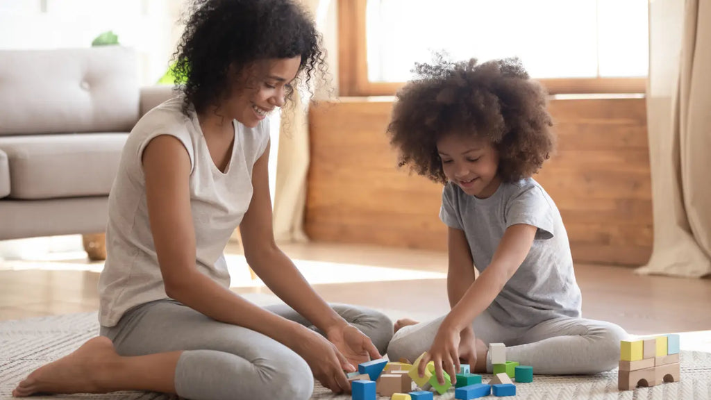 Mom and daughter playing game on the floor