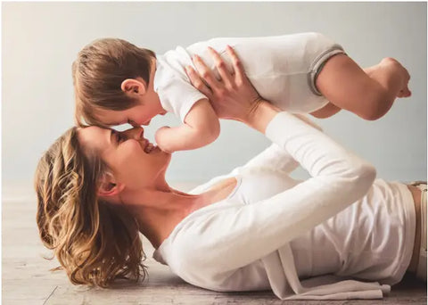 Mother holding her baby and smiling.