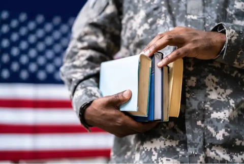 Soldier holding books.