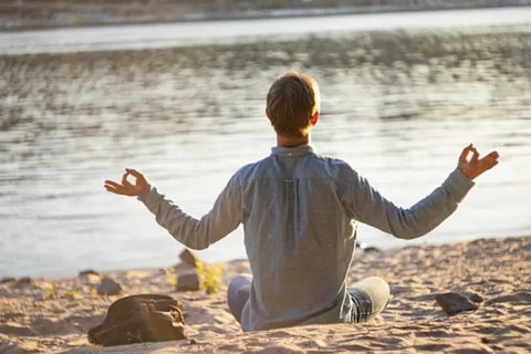 Man meditating at the beach