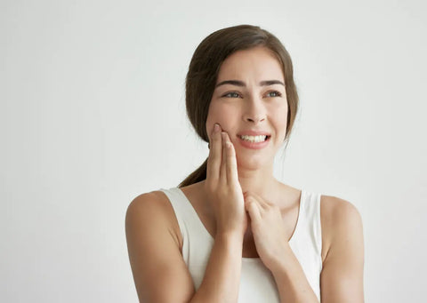 Woman suffering from facial pain.