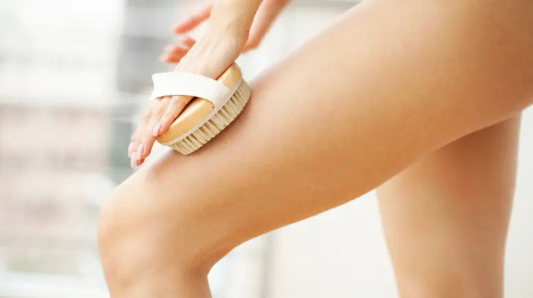 Woman dry brushing her leg