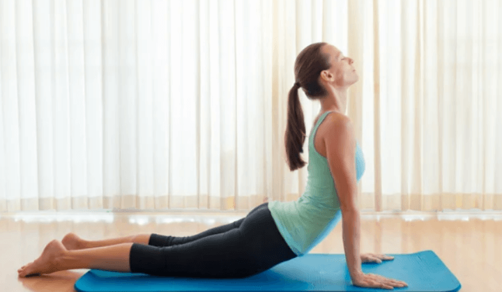 Woman practicing yoga at home