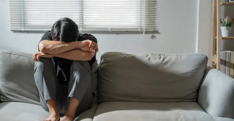 Man sitting on the couch feeling down