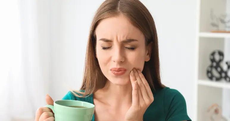 Woman touching her cheek feeling discomfort