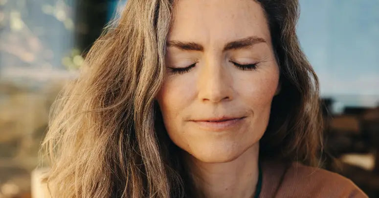 Woman smiling with eyes closed