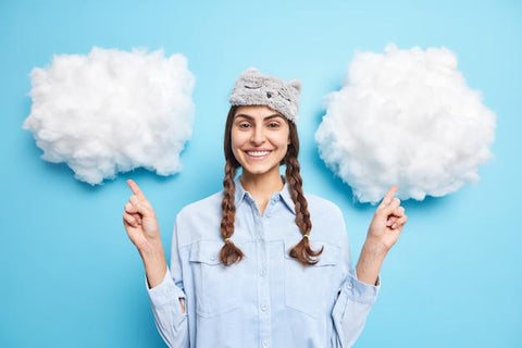 Woman smiling and pointing at cotton clouds