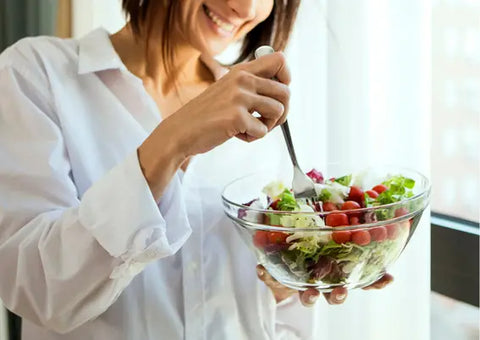 Woman eating a healthy salad.