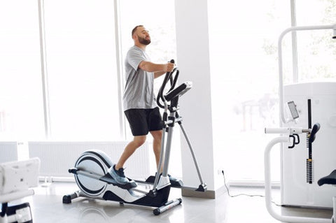 Man using elliptical.