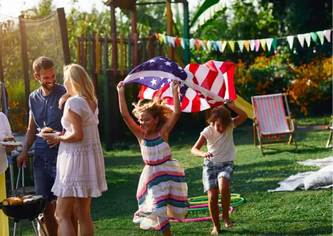 Kids running with the US flag on the 4th of July