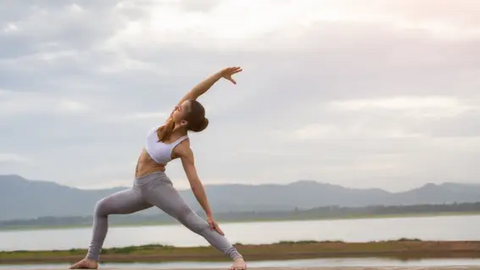 Woman practicing yoga outdoors