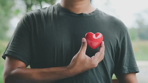 Man holding red heart.