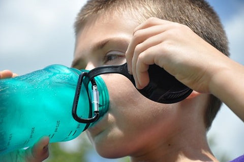 Child drinking water from water bottle.