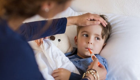 Mom measuring her son's fever