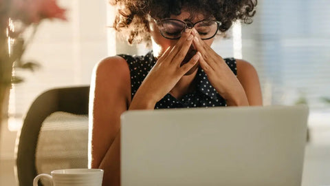 Woman working on her laptop and looking stressed