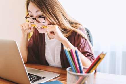 Woman chewing a pen