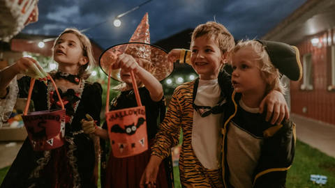 Kids wearing costumes having fun on Halloween