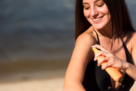 Woman applying sunscreen